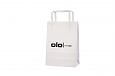 Elegant white paper bag with flat handles in high quality. A.. | Bildgalleri - Vita papperskassar 